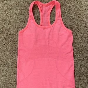 Lululemon swiftly tank. Like new. Size 4. Color is orangy pink.